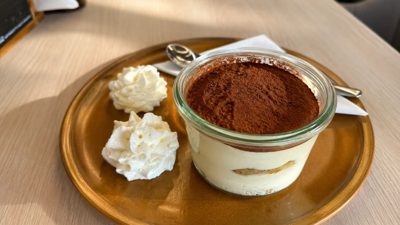 Tiramisù im Glas, mit Kakao bestäubt und Sahnetupfen